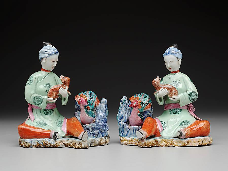Pair of Chinese export porcelain figure groups of seated maidens with spaniels