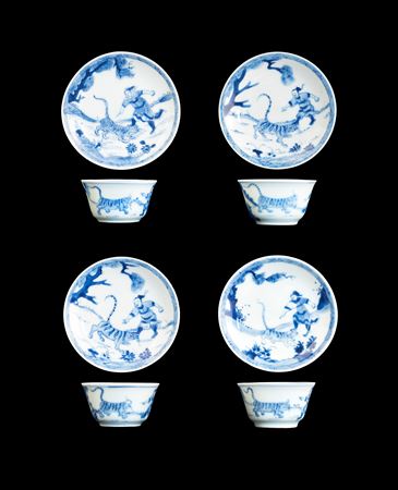 Four Chinese porcelain blue and white teabowls and saucers with Wusong slaying a tiger